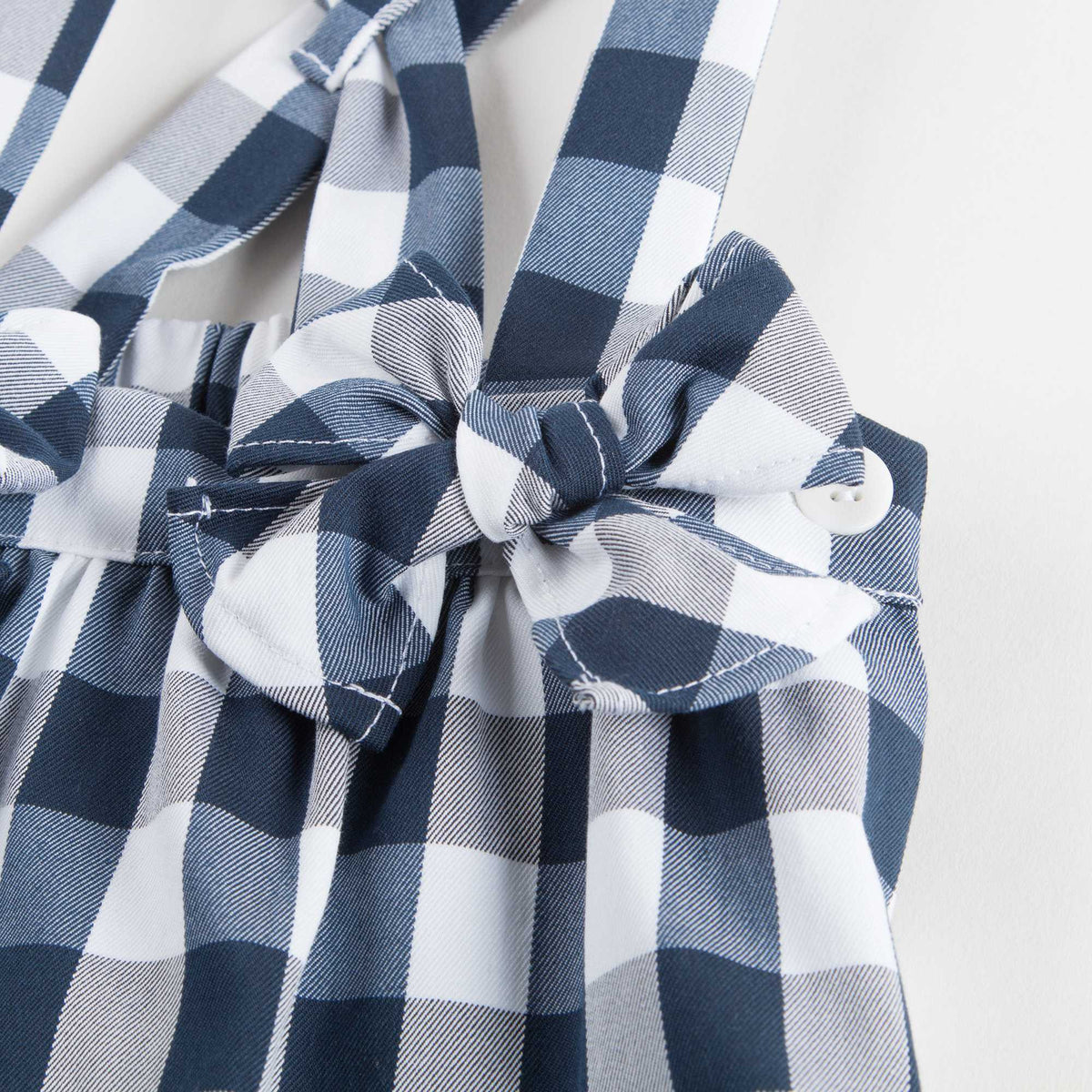 Salopette à carreaux bleu foncé avec nœud pour petites filles