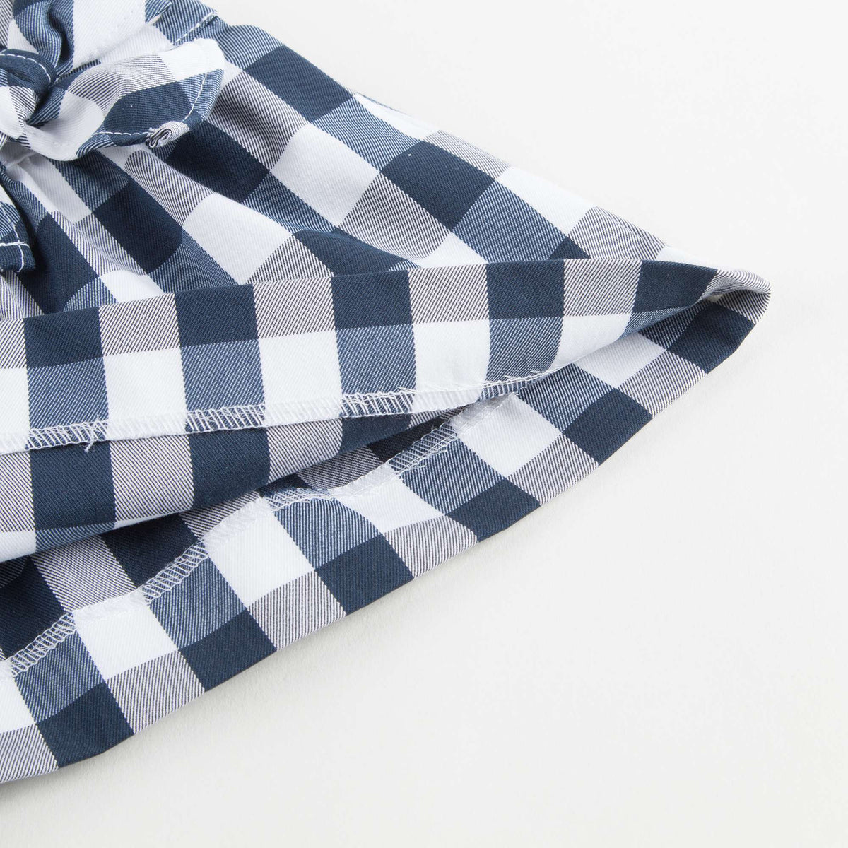Salopette à carreaux bleu foncé avec nœud pour petites filles