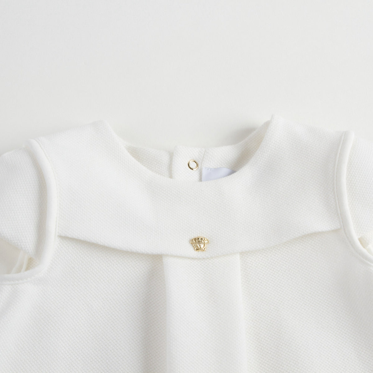Robe bébé fille en coton blanc avec bordures en strass dorés