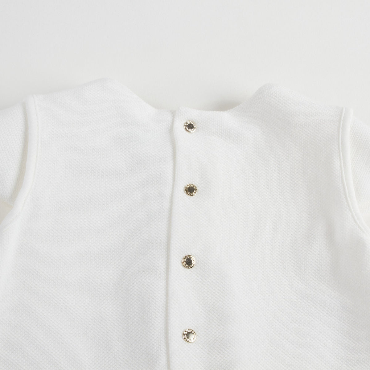 Robe bébé fille en coton blanc avec bordures en strass dorés